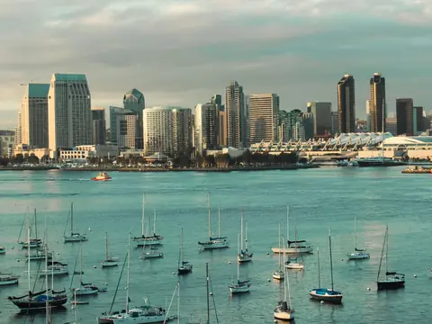 The Downtown San Diego skyline across the bay, with sailboats moored in front