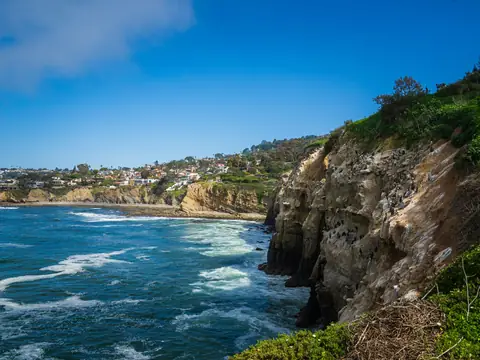 Cliffs and turquoise water along the La Jolla coastline on a clear day